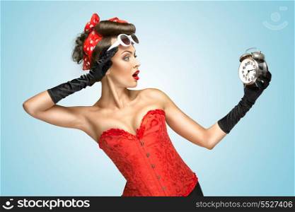 The conceptual photo of a pin-up girl in glamour underwear and gloves watching at the clock.