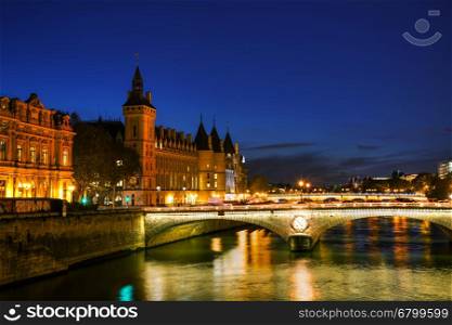 The Conciergerie building in Paris, France in the night