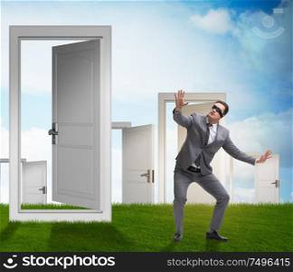 The confused businessman in front of doors. Confused businessman in front of doors
