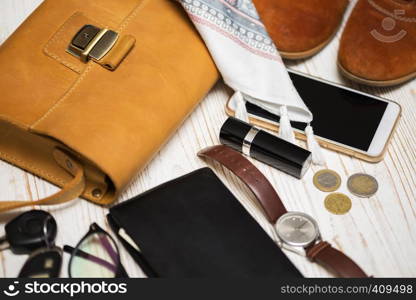 the contents of the female handbag - wallet, keys, phone, lipstick, clock, money, accessories