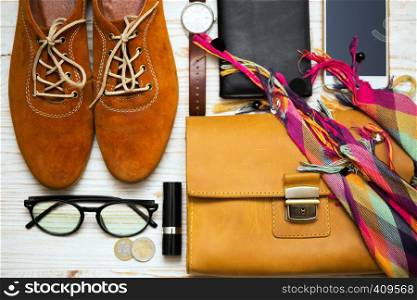 the contents of the female handbag - wallet, keys, phone, lipstick, clock, money, accessories
