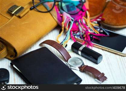 the contents of the female handbag - wallet, keys, phone, lipstick, clock, money, accessories