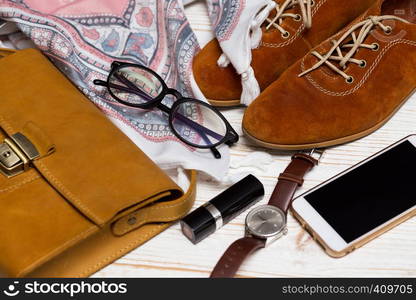 the contents of the female handbag - wallet, keys, phone, lipstick, clock, money, accessories