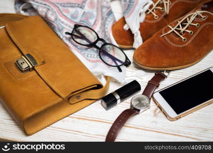 the contents of the female handbag - wallet, keys, phone, lipstick, clock, money, accessories