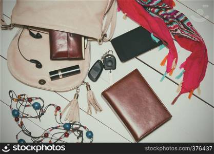 the contents of the female handbag - wallet, keys, phone, lipstick, perfume. vintage