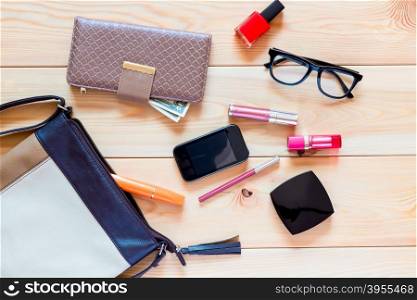 the contents of women&rsquo;s handbags are scattered on the floor