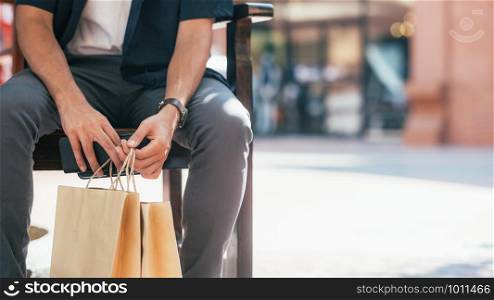 The copyspace of close up of man hand holding shopping bags