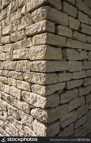 The corner of an old stone house in the Luberon area of Prevence, France showing the contrast of one wall in bright sun and the other in deep shade.