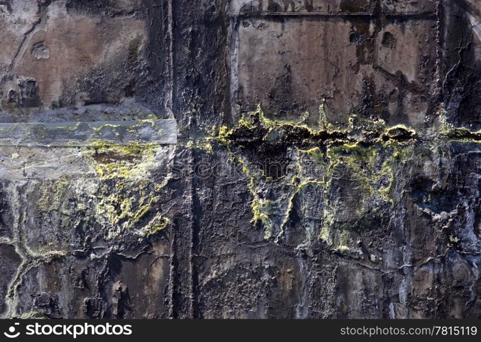 The corroded grungy structures of an industrial waste water tank, showing the crystallinisation of the various minerals, such as the yellow sulphur - Also very useful as grunge background