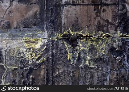 The corroded grungy structures of an industrial waste water tank, showing the crystallinisation of the various minerals, such as the yellow sulphur - Also very useful as grunge background