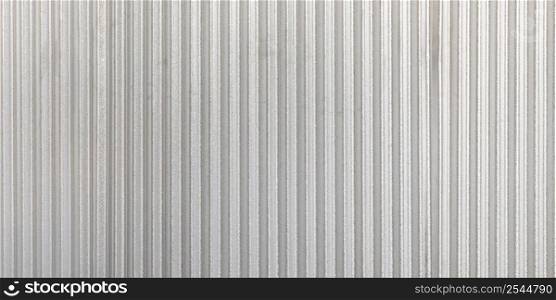 The corrugated grey metal panorama wall background. Rusty zinc grunge texture and background.