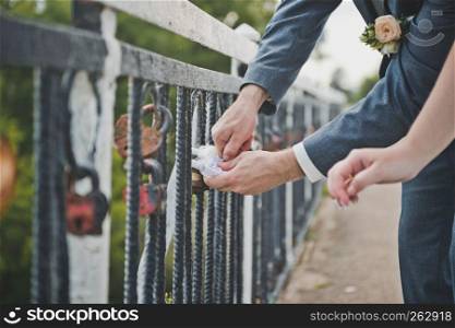 The couple closed the key lock on the bridge.. Husband and wife lock the lock for good luck 1947.
