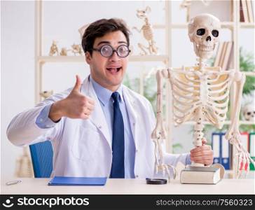 The crazy professor studying human skeleton. Crazy professor studying human skeleton