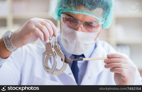 The criminologist police chemist looking at crime evidence. Criminologist police chemist looking at crime evidence