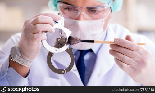 The criminologist police chemist looking at crime evidence. Criminologist police chemist looking at crime evidence