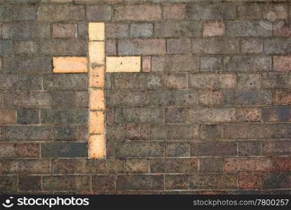 the cross of christ built into a brick wall as background. cross of christ built into a brick wall