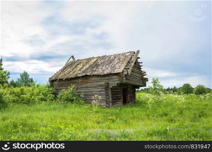 The crumbling barn in the defunct village Burdovo, Kostroma oblast, Russia.