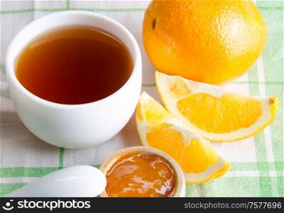 The cup of tea served with orange jam. Cup of tea served with orange jam