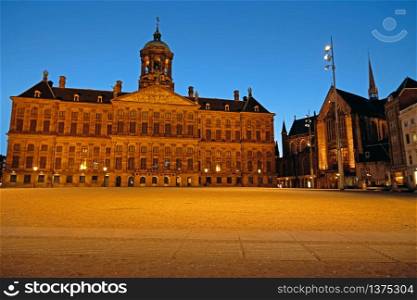 The Dam Square in Amsterdam Netherlands with the the Royal Palace at sunset