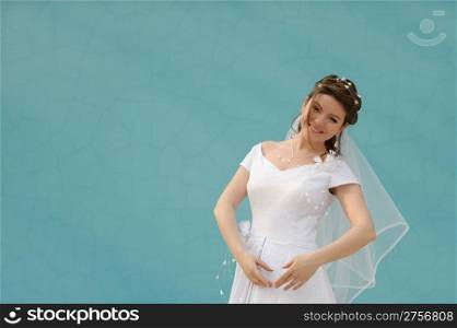 The dancing bride. The young girl in a wedding dress on an abstract background. East dance
