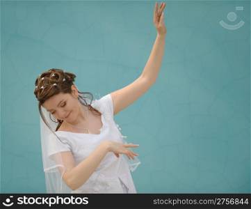 The dancing bride. The young girl in a wedding dress on an abstract background. East dance