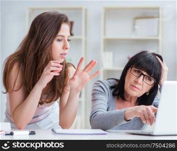 The daughter explaining to mom how to use computer. Daughter explaining to mom how to use computer