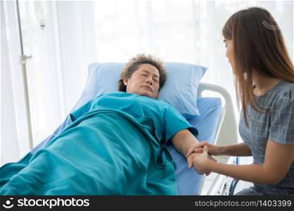 The daughter visits the grandmother who is sick in the hospital.