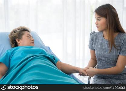 The daughter visits the grandmother who is sick in the hospital.