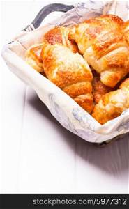 The delicious croissants in a basket for breakfast. The fresh croissants