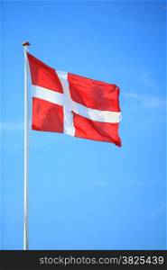 The denmark or danish flag with blue sky on background
