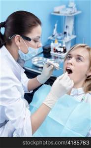 The dentist examines a patient