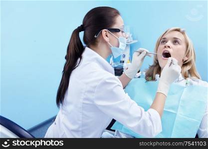 The dentist examines a patient