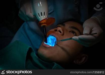 The dentist is treating the patients? teeth in a dental clinic.
