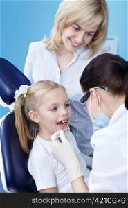 The dentist makes examination of the child