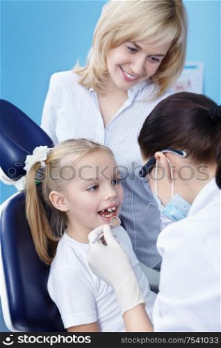 The dentist makes examination of the child