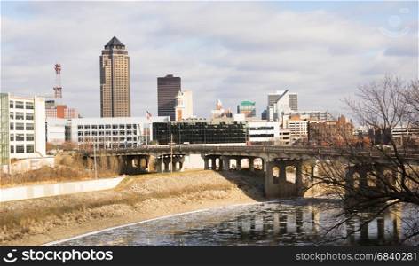 The Des Moines river running with ice chunks travel through downtown