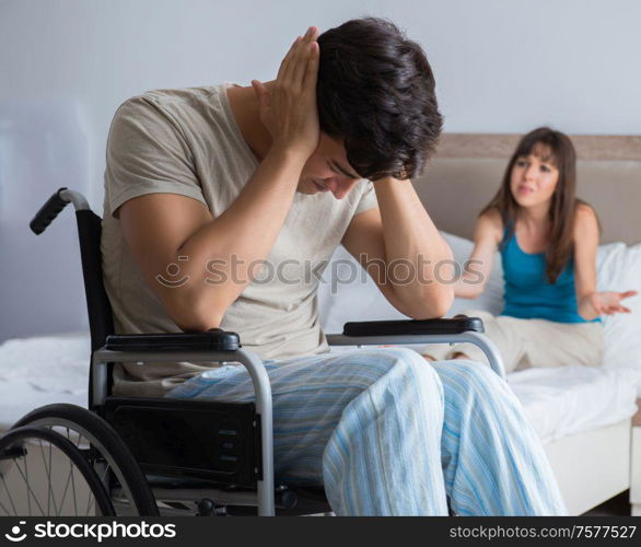 The desperate man on wheelchair with his sad wife. Desperate man on wheelchair with his sad wife