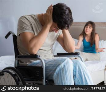 The desperate man on wheelchair with his sad wife. Desperate man on wheelchair with his sad wife