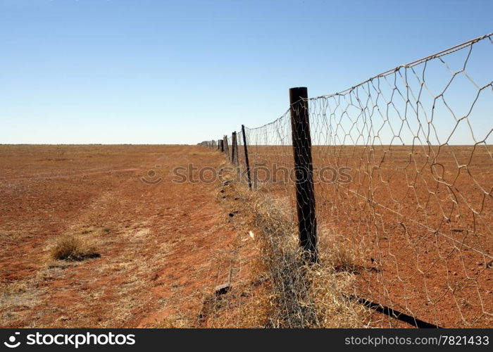The Dingo fence in the Australian Outback. Fence is 9600 km long and spans the entire country, keeping the dingoes out of the south where sheep graze.