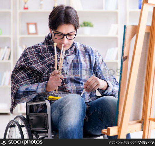 The disabled artist painting picture in studio. Disabled artist painting picture in studio