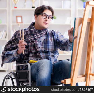 The disabled artist painting picture in studio. Disabled artist painting picture in studio