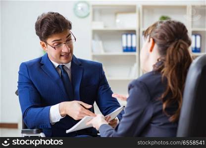 The disabled businessman having discussion with female colleague. Disabled businessman having discussion with female colleague. The disabled businessman having discussion with female colleague