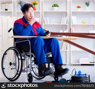 The disabled carpenter working in workshop. Disabled carpenter working in workshop
