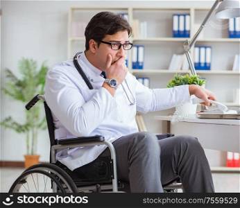 The disabled doctor on wheelchair working in hospital. Disabled doctor on wheelchair working in hospital
