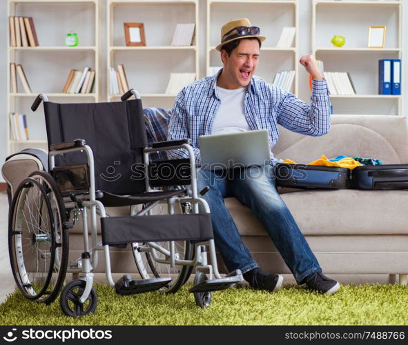 The disabled man booking travel online using laptop computer. Disabled man booking travel online using laptop computer