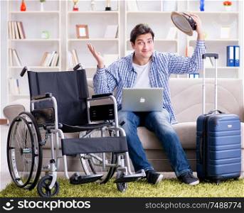 The disabled man booking travel online using laptop computer. Disabled man booking travel online using laptop computer