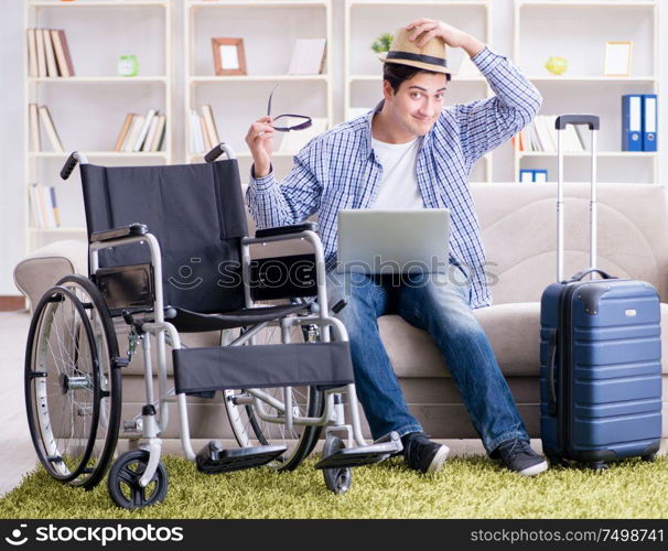 The disabled man booking travel online using laptop computer. Disabled man booking travel online using laptop computer