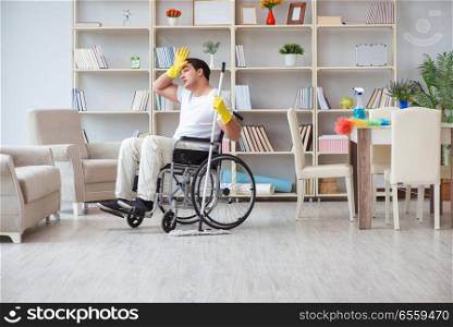 The disabled man cleaning floor at home. Disabled man cleaning floor at home