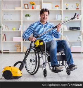 The disabled man cleaning home with vacuum cleaner. Disabled man cleaning home with vacuum cleaner