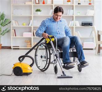 The disabled man cleaning home with vacuum cleaner. Disabled man cleaning home with vacuum cleaner